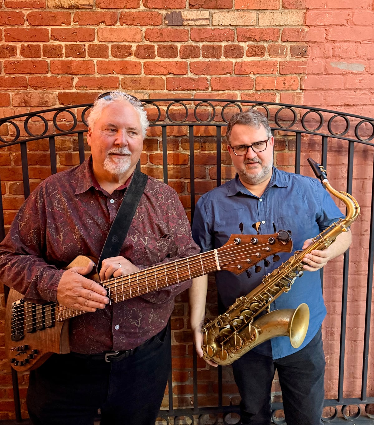 Paul Westlake and Rob Denty at a wrought-iron gate